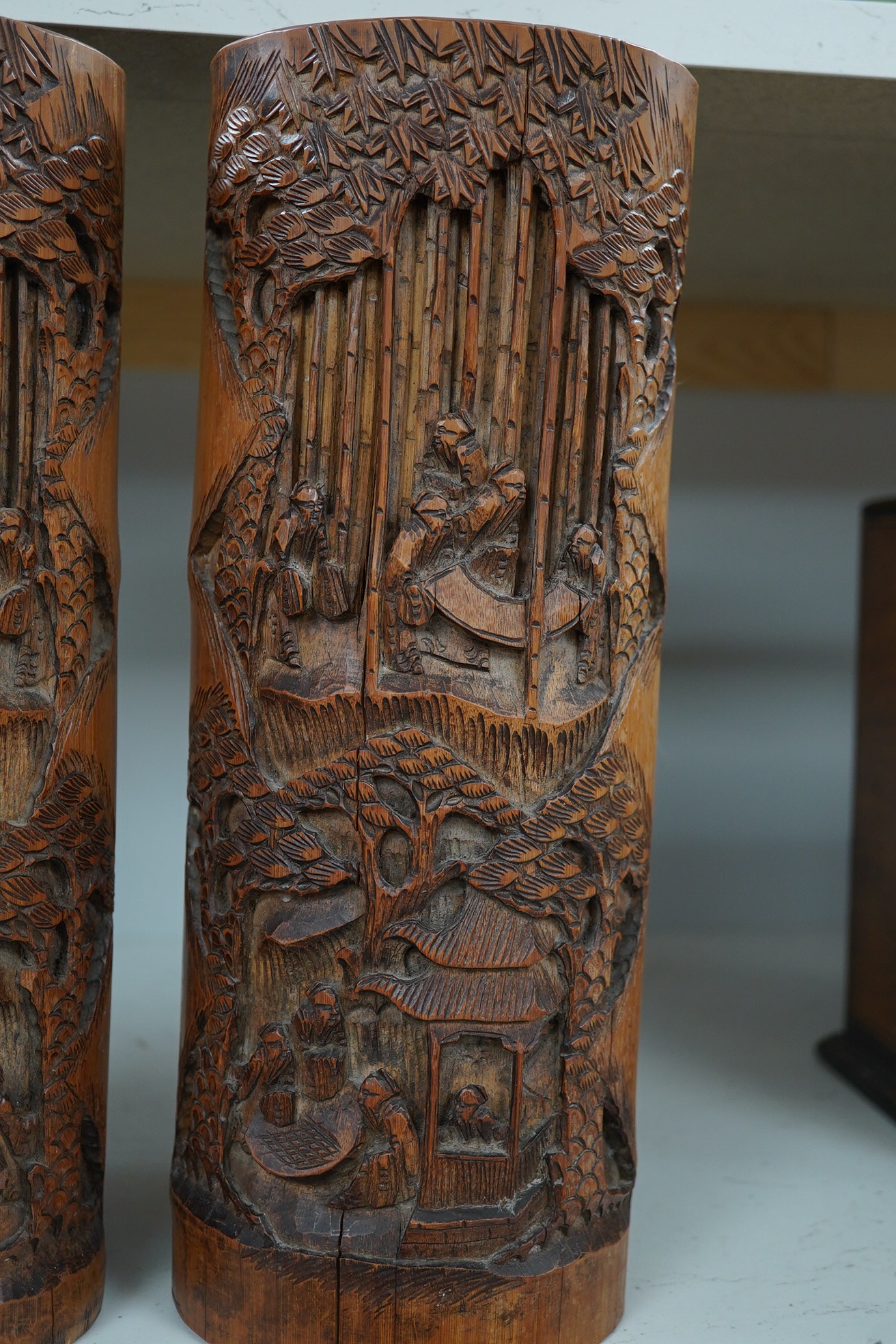 A pair of Chinese bamboo ‘seven sages of the bamboo grove’ brushpots, 33cm high. Condition - some splits